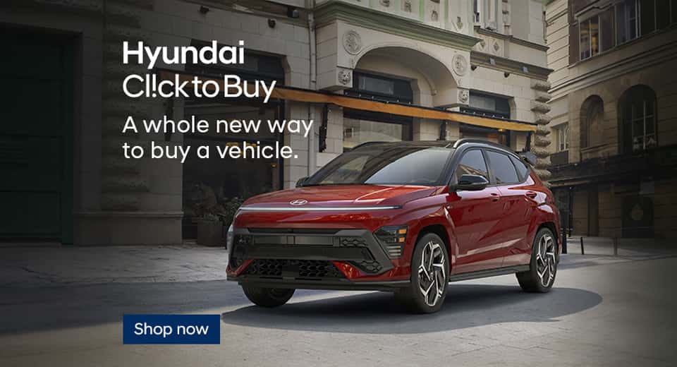 A red Kona parked on a cobbled city street. A whole new way to buy a vehicle. Hyundai ClicktoBuy.